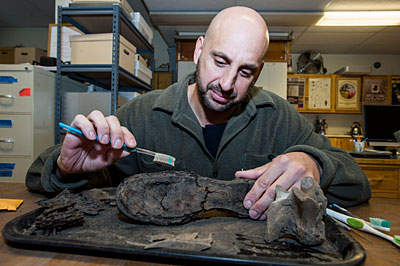 Doctoral student Tommy Livoti, shown here in the UM Archeology Lab, is working to create a military unit to protect antiquities during warfare.