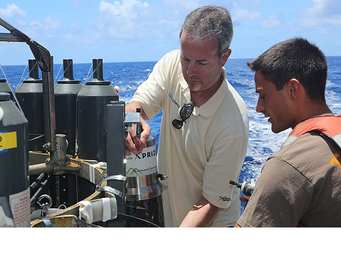 Sunburst CEO Jim Beck (left) recovers his company’s tSAMI device after its return from 3,000 meters underwater off the coast of Hawaii during Phase 4 of the ocean health XPRIZE competition. (XPRIZE photo)