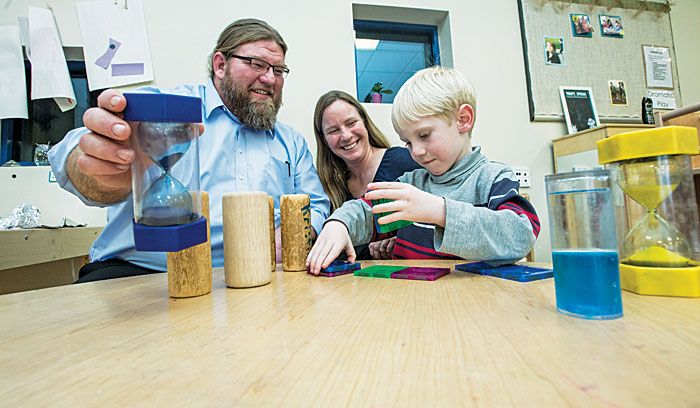 UM Professor Trent Atkins, shown here with his wife, Rachel, and 5-year-old son Abe, has launched a private company to promote reading skills for young children.