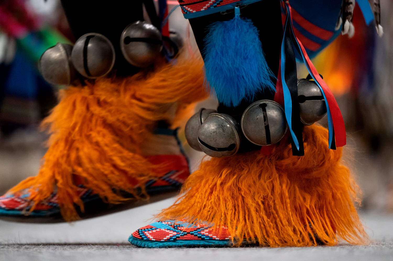 men's beaded moccasins with orange sheepskin and brass bells