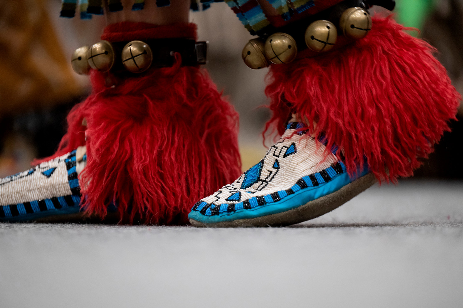 men's beaded moccasins with red sheepskin and brass bells