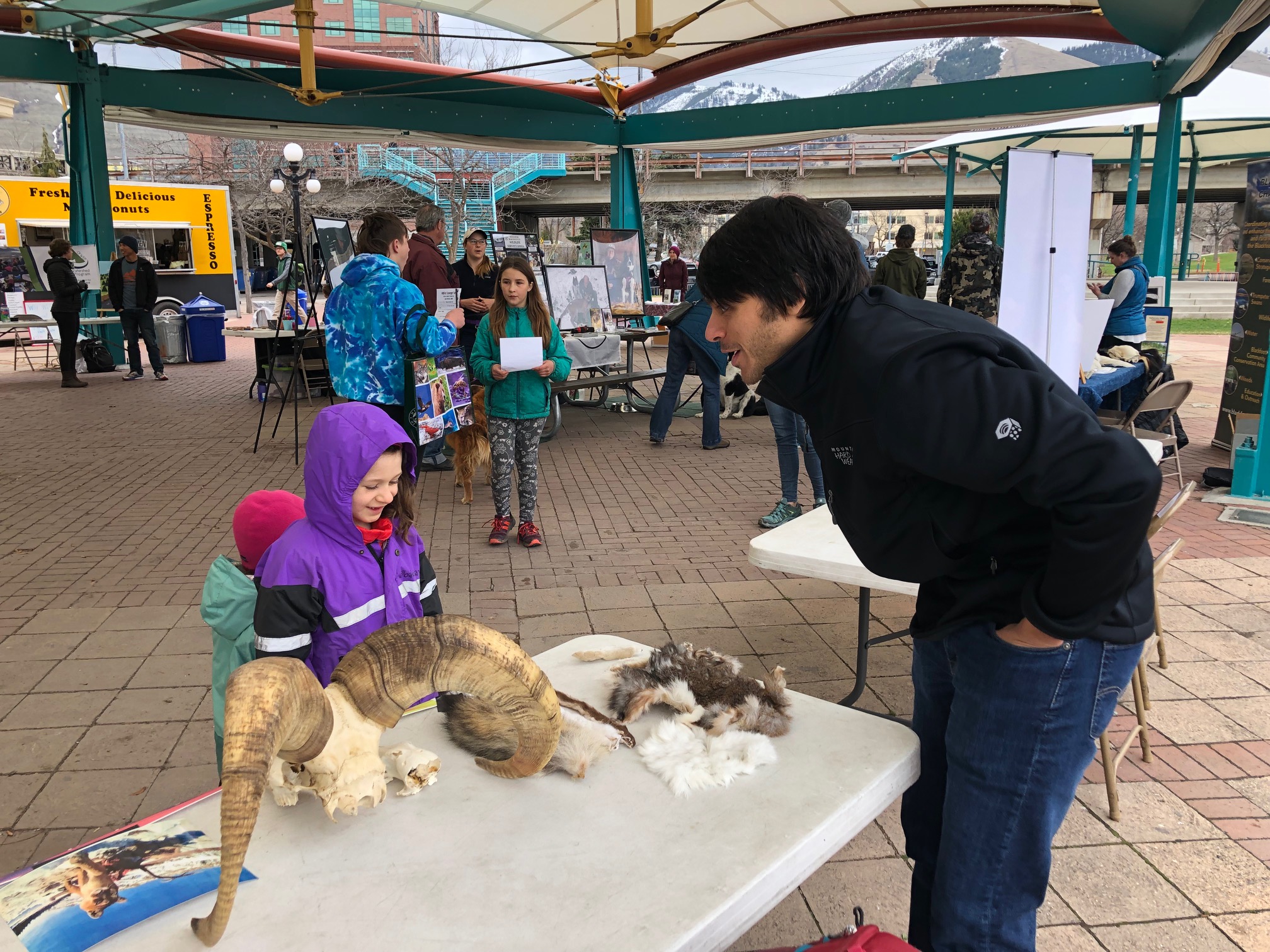 Photo of Alex explaining the benefits of seasonal coat color change to kids at Wild Fest