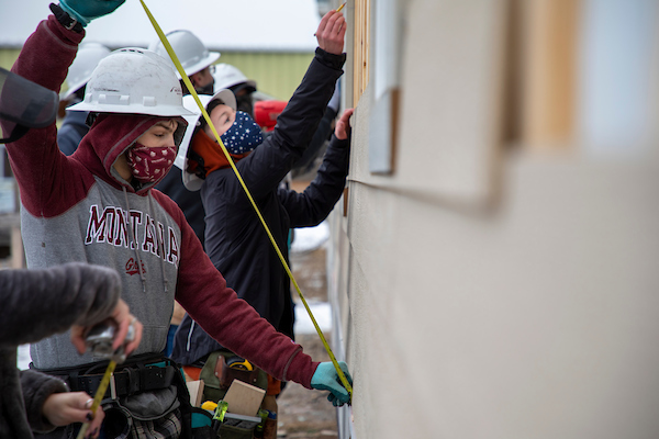 Workforce ready. Student holding a tape measure.