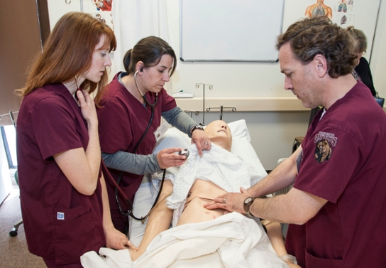 CNA students with simulator