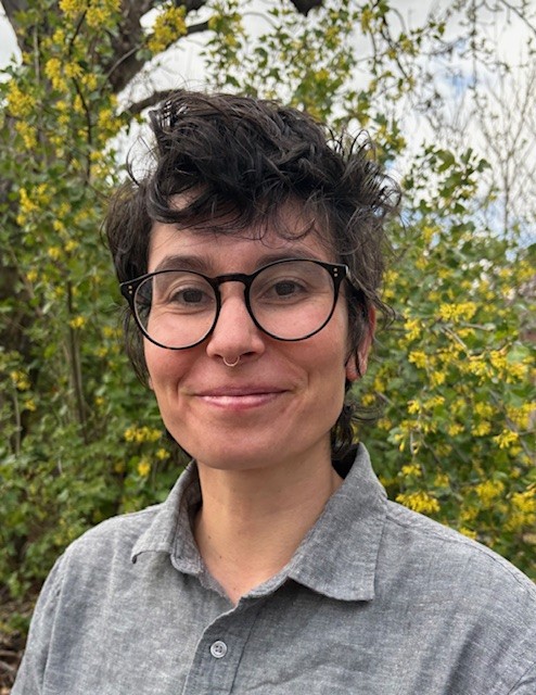 Dr. Julie Olomi standing in front of a shrub