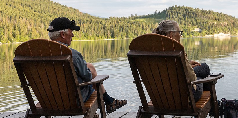 Seniors sitting on lake dock