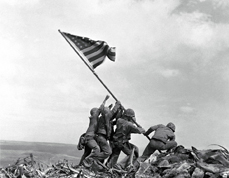 US Marines raise American flag atop Mount Suibachi on Iwo Jima in the South Pacific
