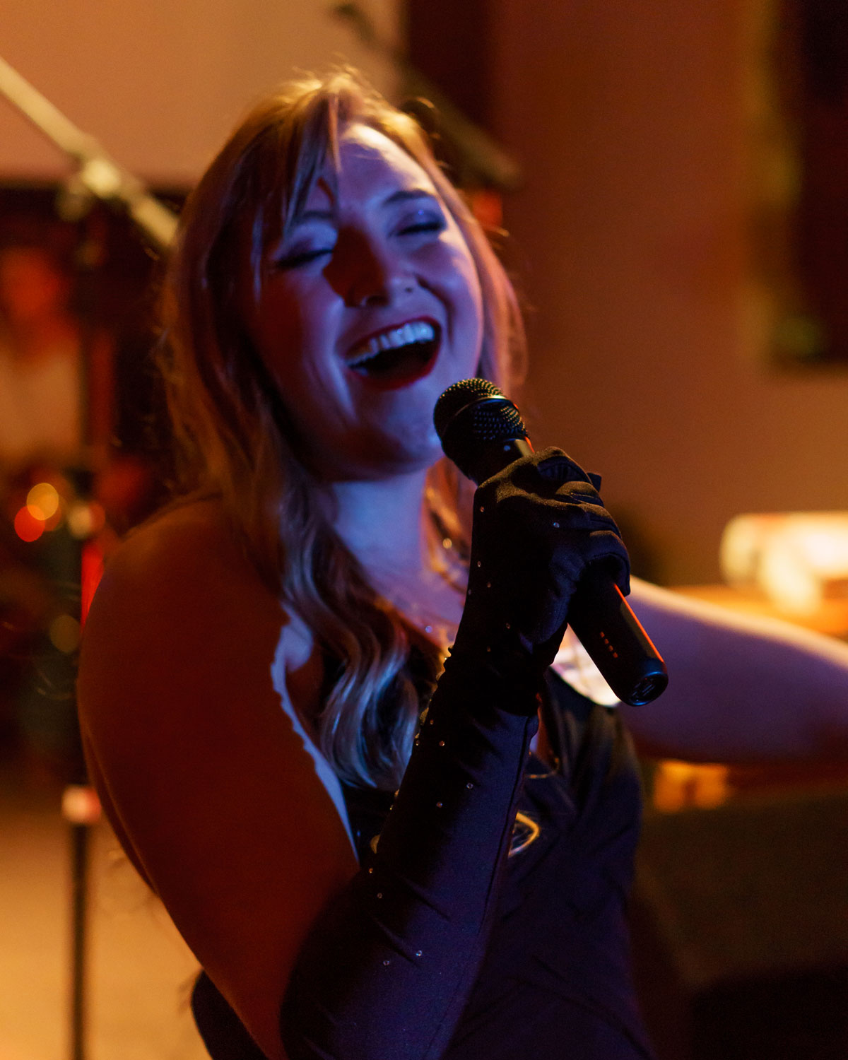 Photo of Hannah Bondurant singing into a microphone