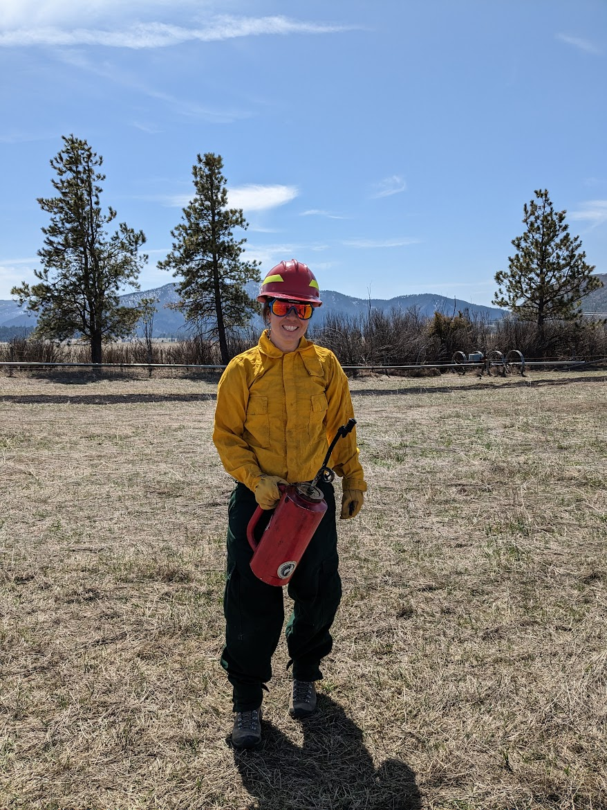 A wild land firefighter holding a drip torch