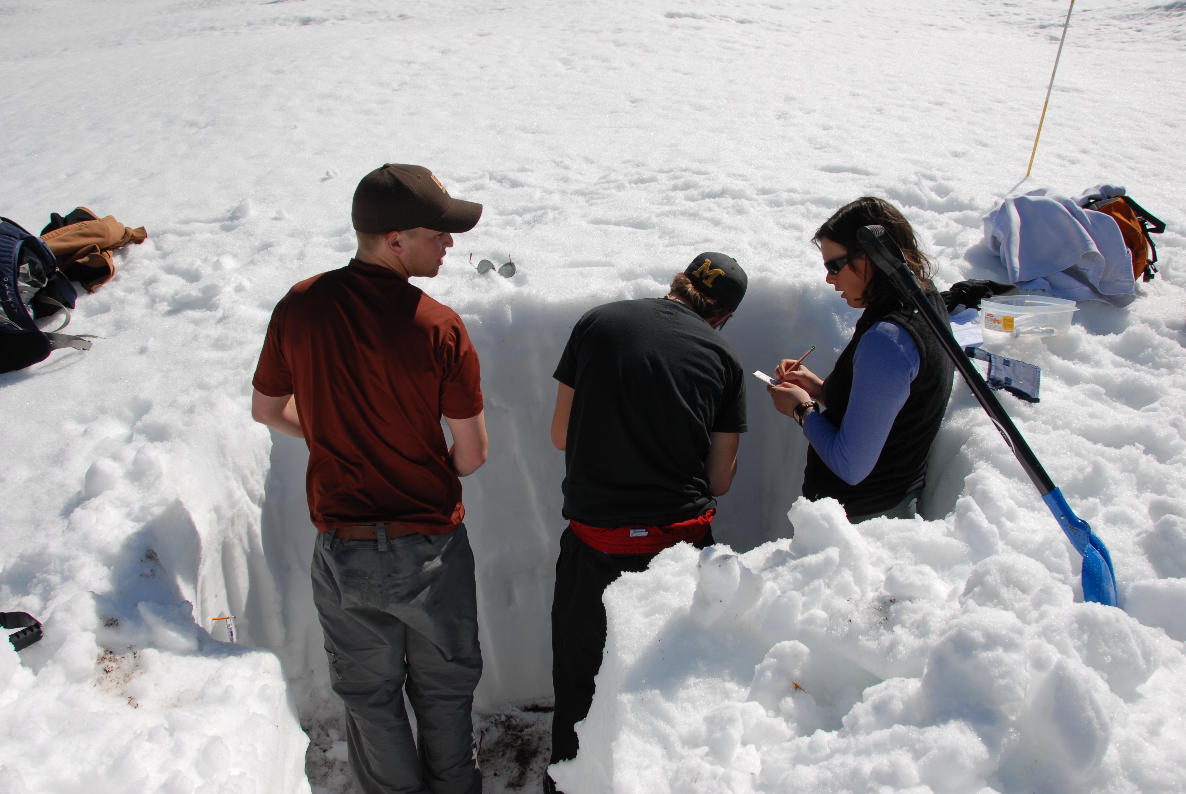 students standing in ice hole