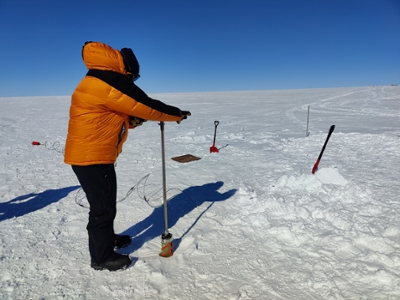 Scientist drilling ice