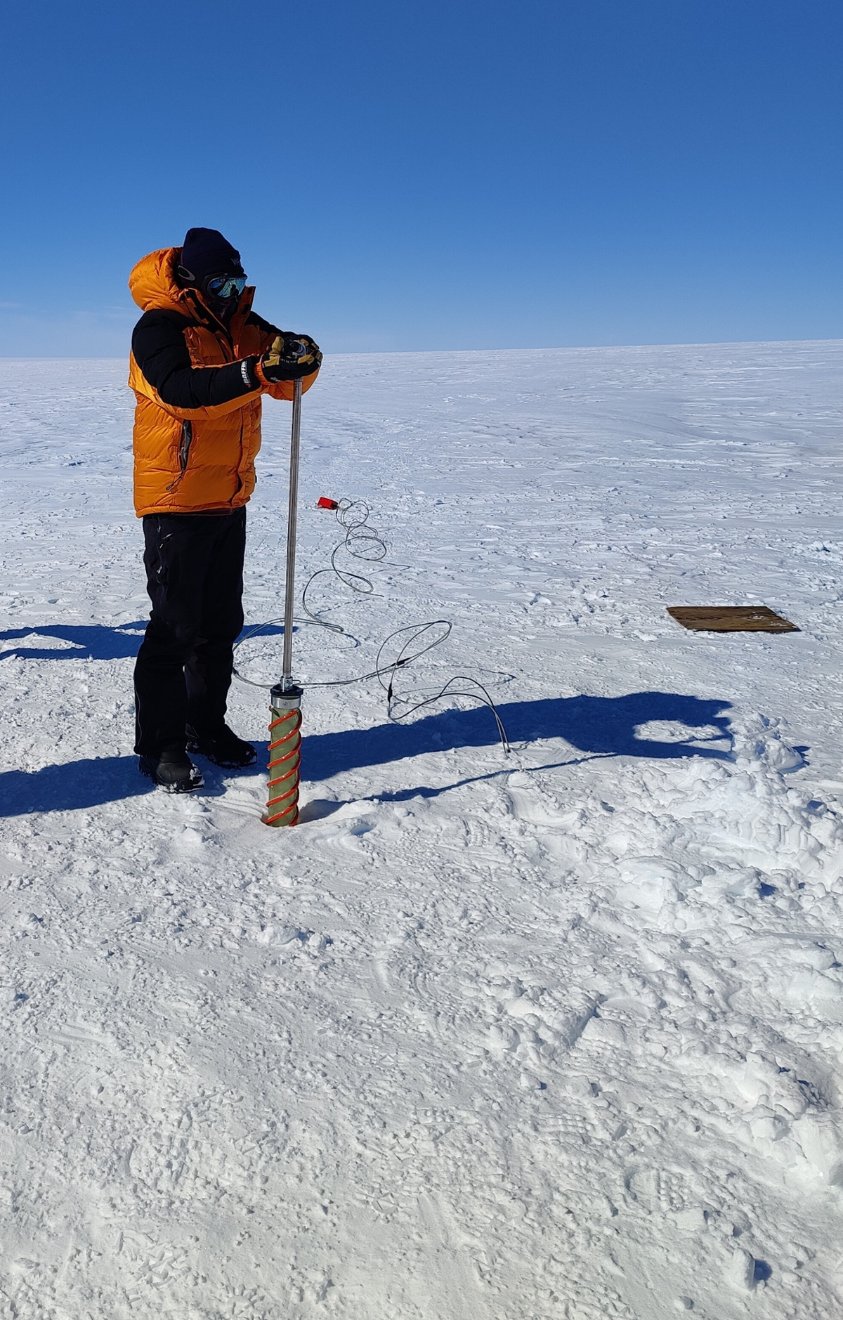 scientist drilling ice