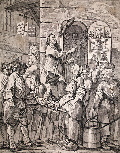 A historical illustration depicting a lively public performance, with a crowd gathered around a performer gesturing dramatically while others hold various items.