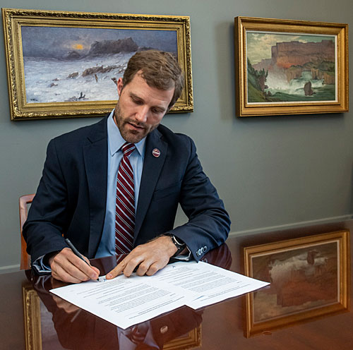 UM President Seth Bodnar signs the MOU.