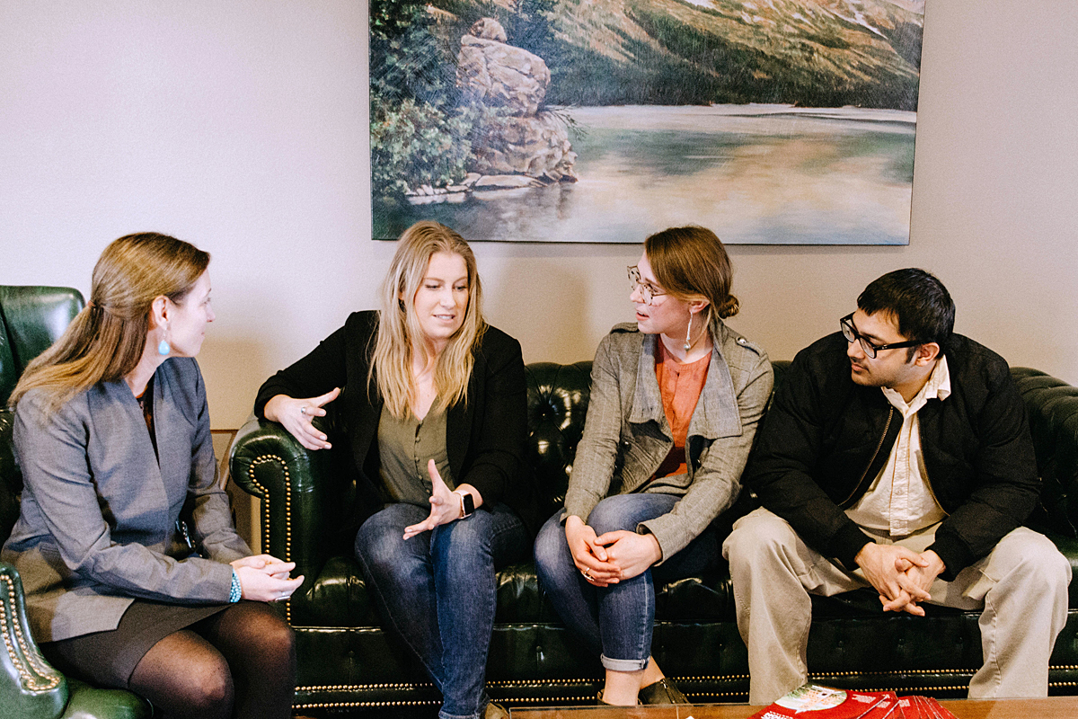 Photo of students meeting with faculty member.