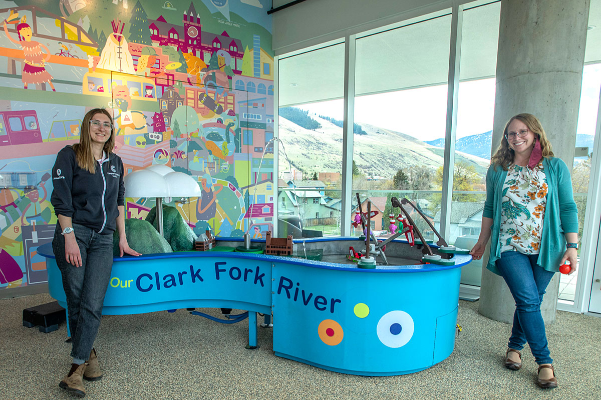 SpectrUM Director Jessie Herbert-Meny (right) and AmericCorp leader Brooke Carey reveal part of the discovery area’s new digs within the Missoula Public Library building.