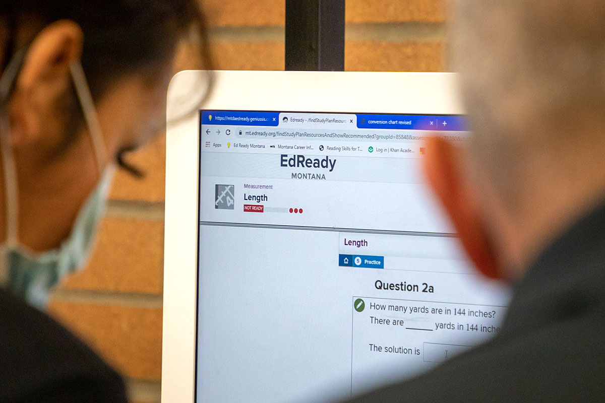 Two adult learners look at the EdReady website.