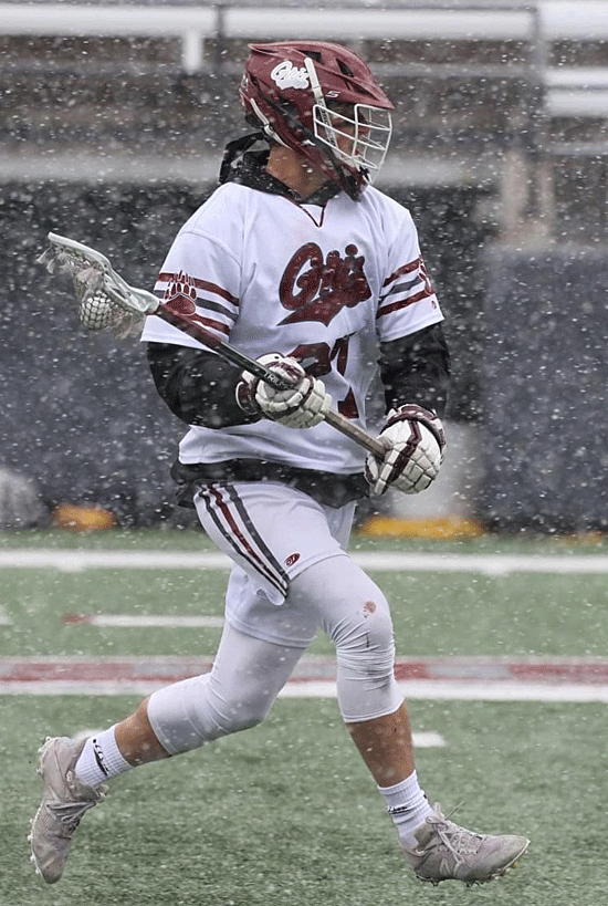 A Griz lacrosse player practices in the snow. 