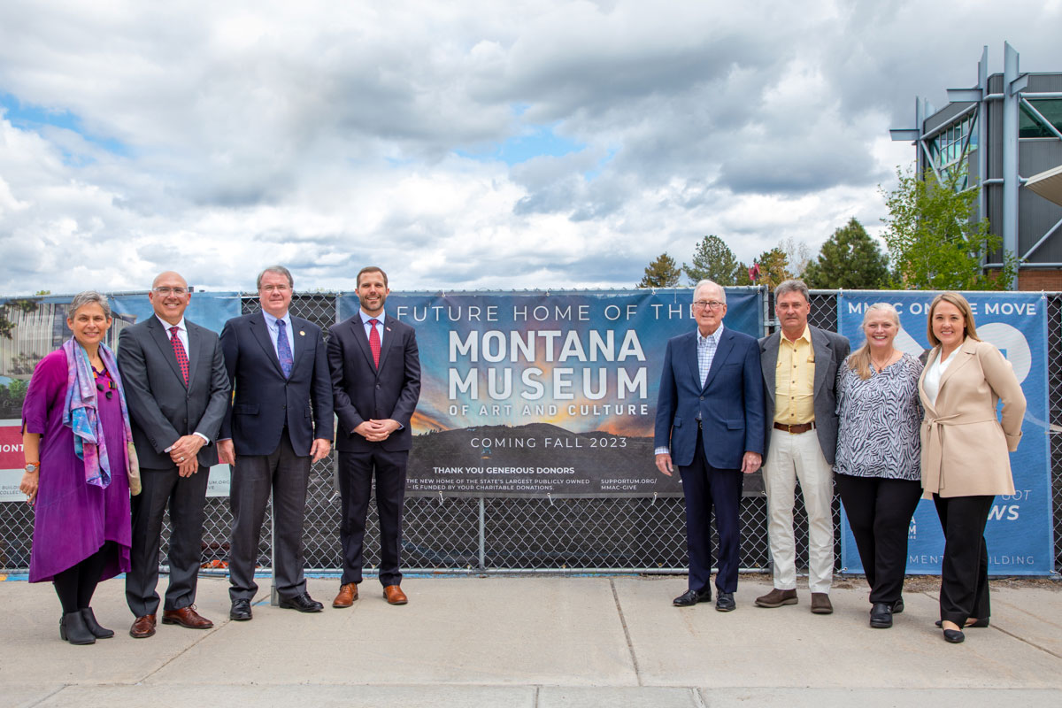 An esteemed group posing a the construction site of the new Montana Museum of Art and Culture.