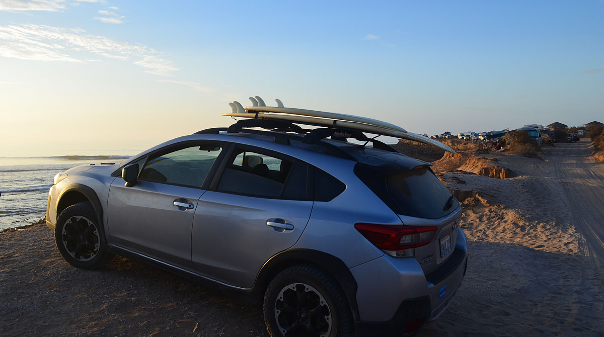 Surfboards are strapped to Garcia-Arce's car at the beach in Scorpion Bay.