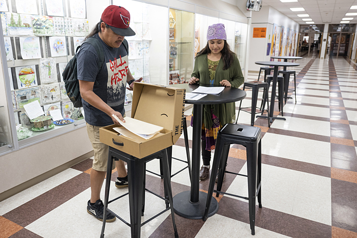 Eighth grade Ronan Middle School student JuDaya Azure-Matt reviews her grades with Chase.