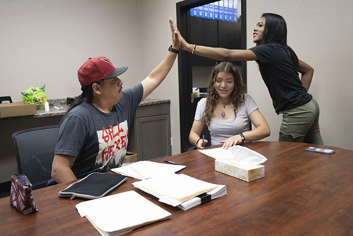 Ronan High School student Aaliyah Steward high-fives Stephan Chase, Montana American Indians in Math and Science associate director, during a grade check.