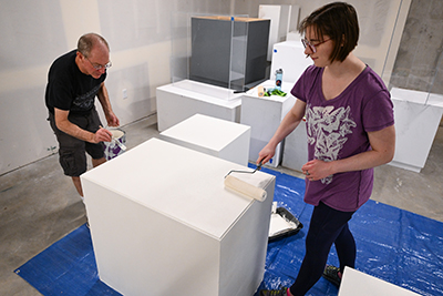 Photo of Tom Bensen painting pedestal