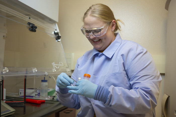 A picture of UM graduate student Elizabeth Lorentz working in the lab.