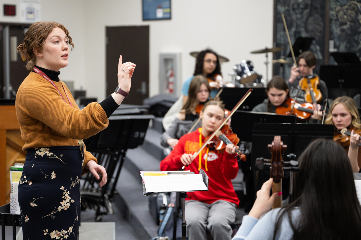 An image of UM student Marian Kale instructing a high school music classroom. 
