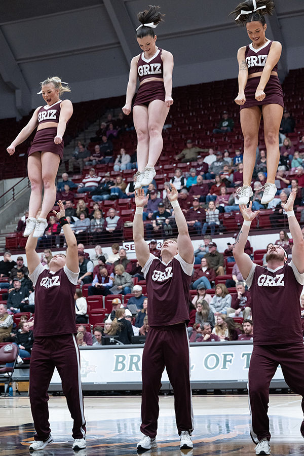 Photo of the Smith's performing a stunt at a basketbal game