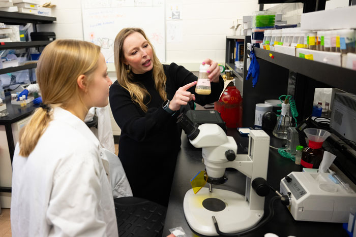 Beverly Piggott works with a student in her UM lab.