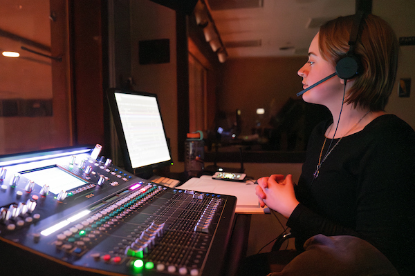 Photo of student operating a soundboard