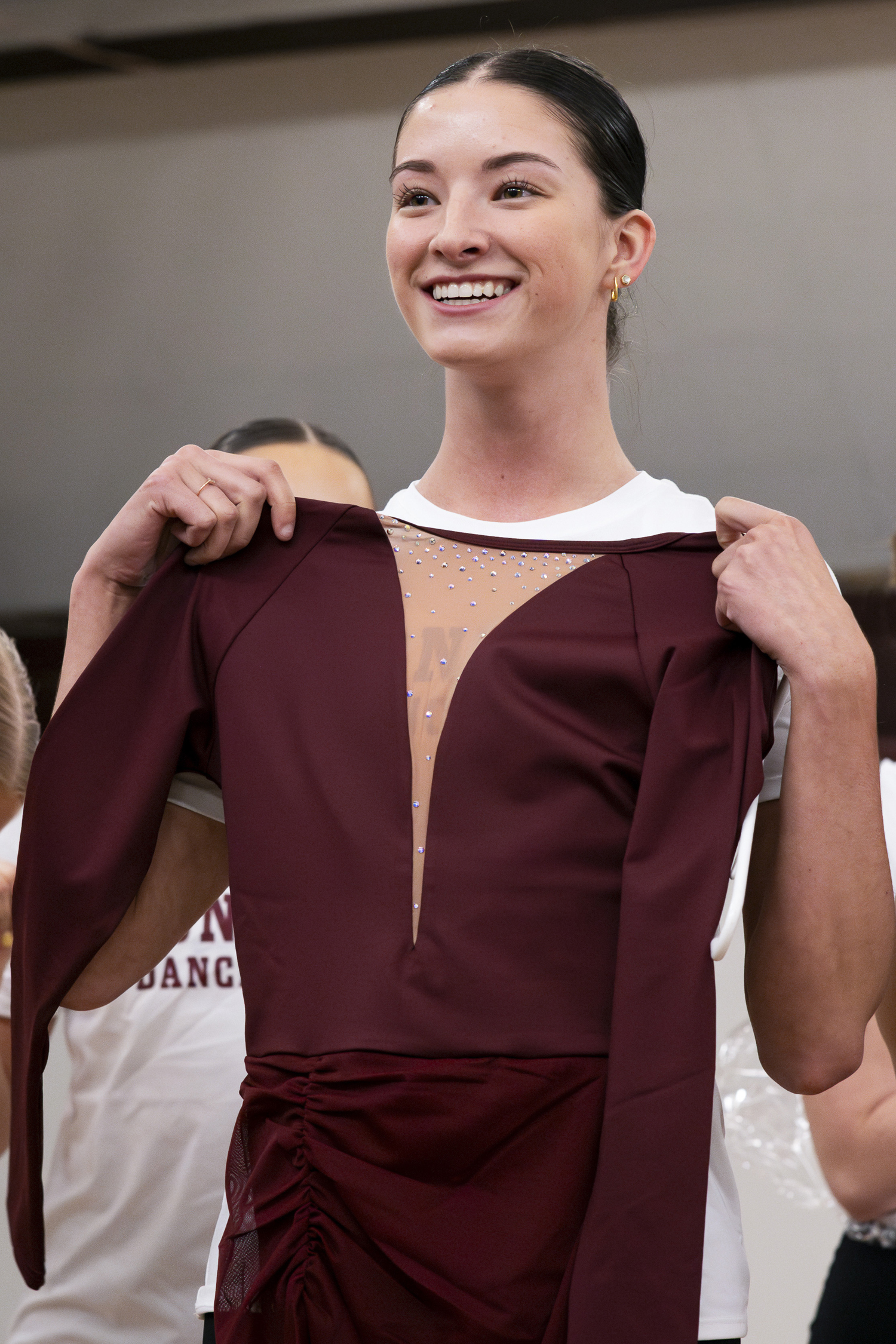 Andrea Newbrough holds up her competition uniform. 