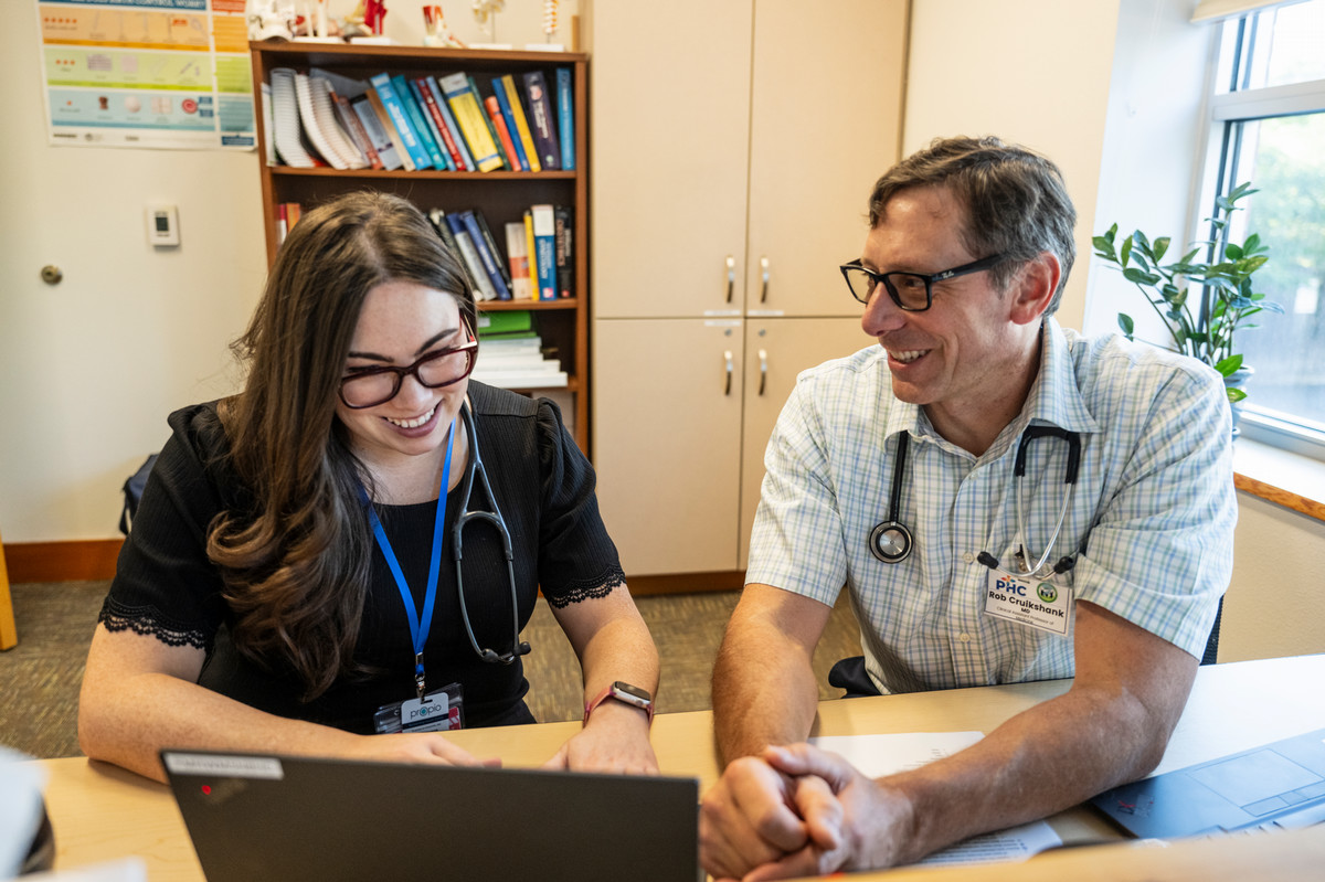 Dr. Rob Cruikshank works with a resident at Partnership Health Center in Missoula.