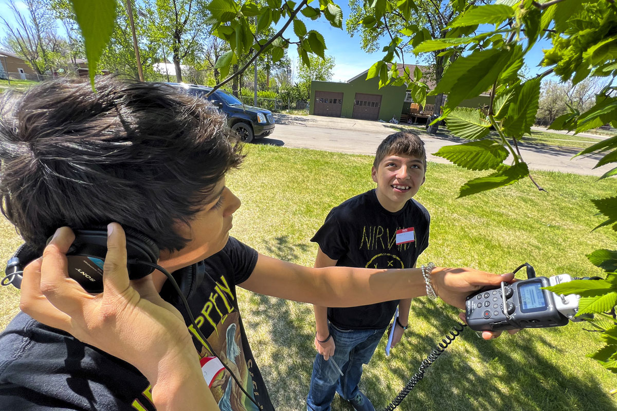 Two Montana Media Lab students work with audio equipment.