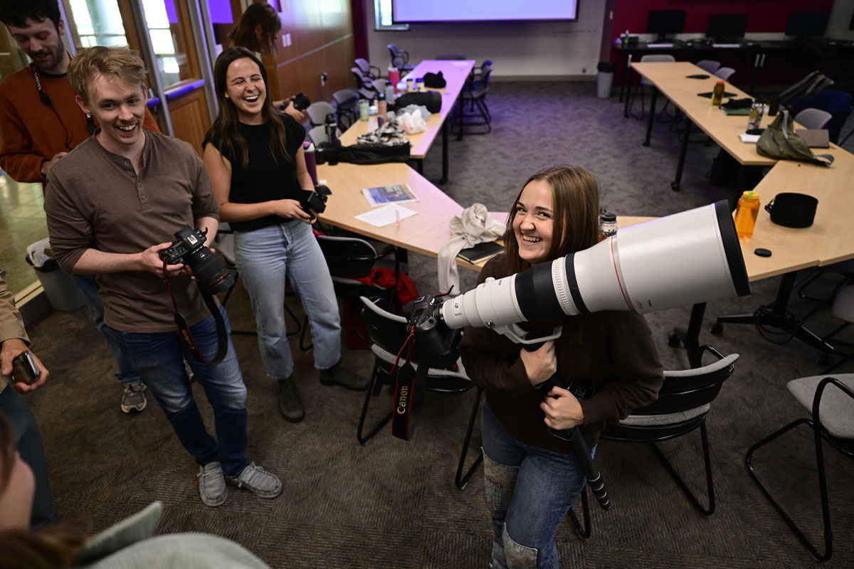 Ella Palulis, a sophomore at UM, smiles with equipment she will be using during the UM Journalism School’s innagural photography workshop. UM students and early career photojournalists from across the nation came to campus for the photography intensive. 