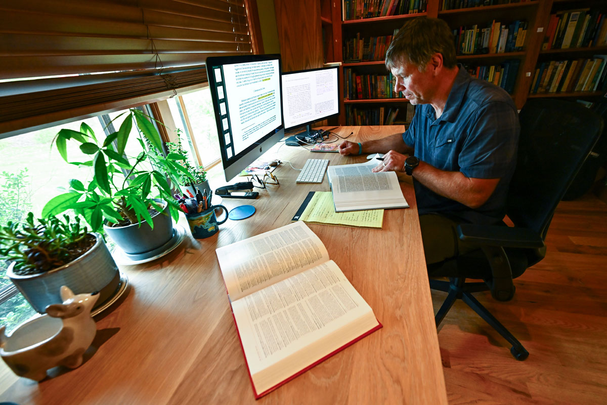 A picture of Craig Rigdon studying at his table.