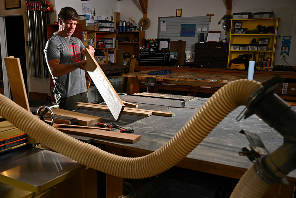 Rigdon examines a board in this shop.