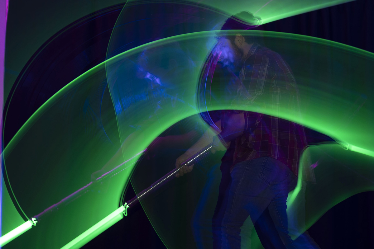 An image of two members of UM's Lightsaber Dueling Club engaged in battle. 