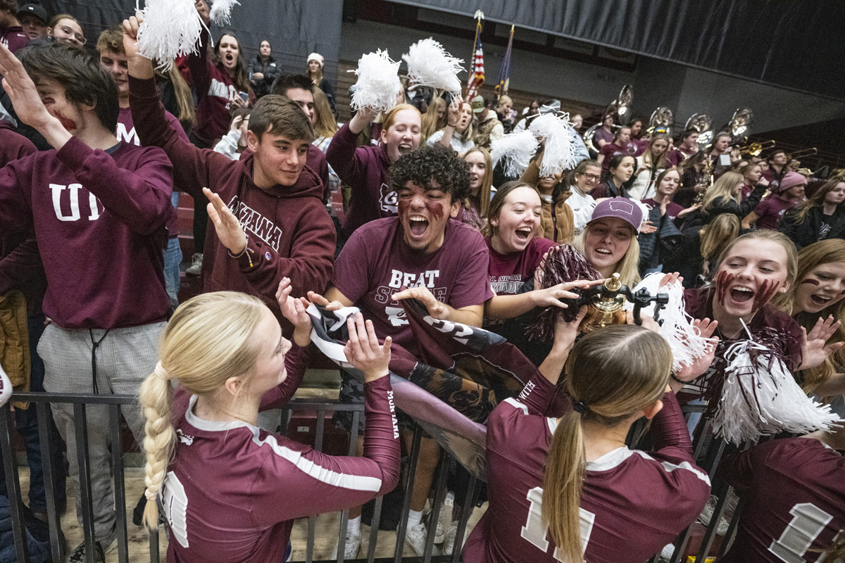 Zoo Crew members cheer at a Griz Volleyball game.