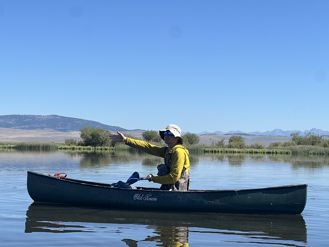 Professor Thomas Riecke works in a canoe.