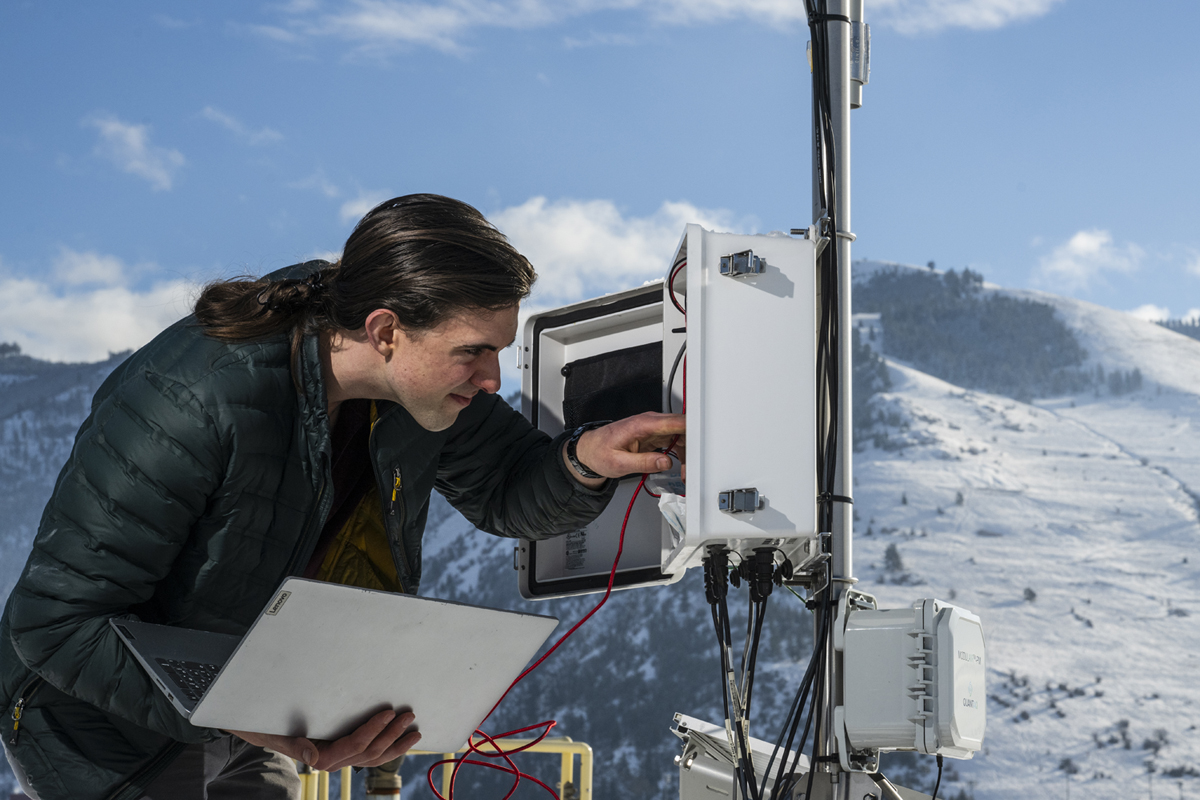 A photo of Joseph Knudsen working on the HART Station on top of the Missoula Public Library. 