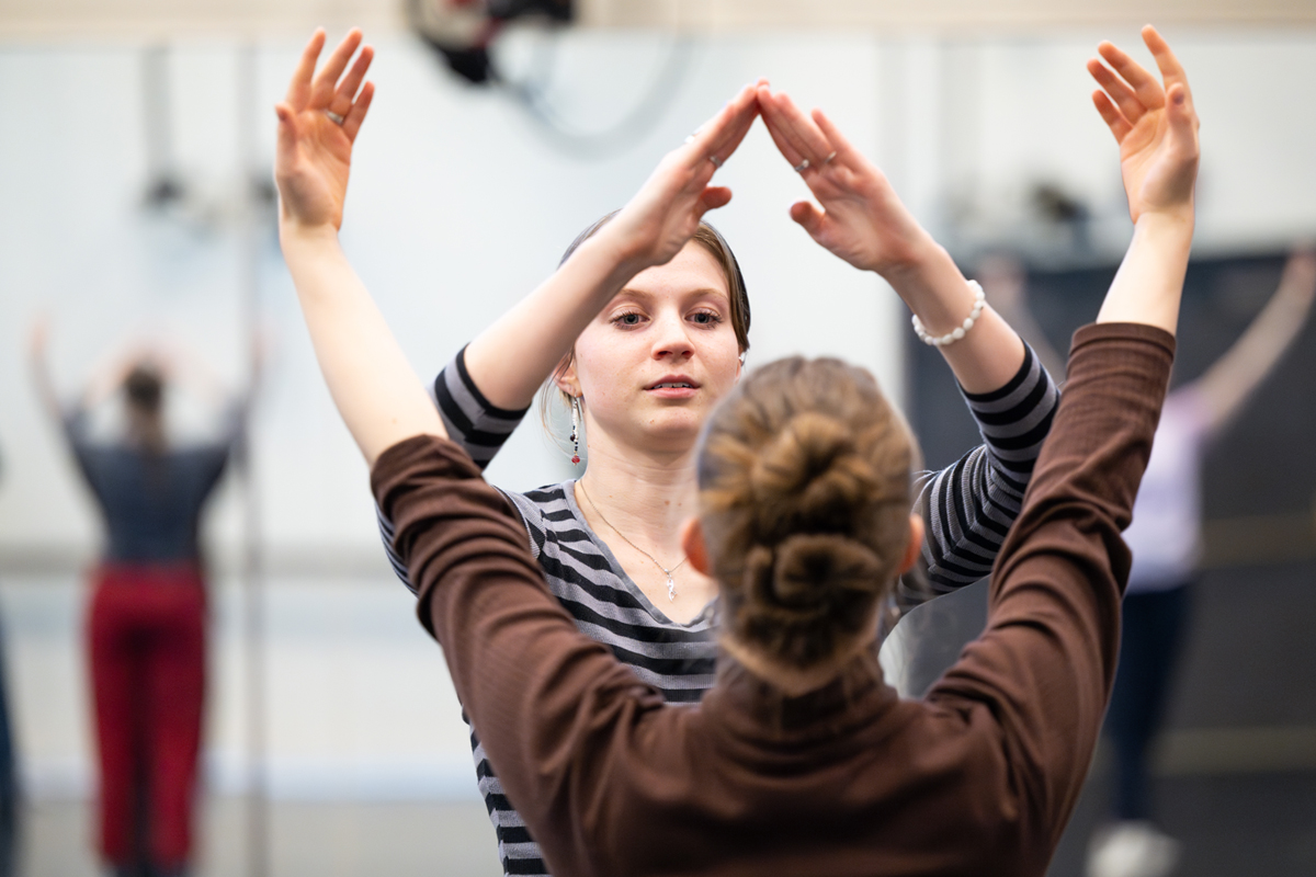 A photo of Ferguson leading rehearsal. 