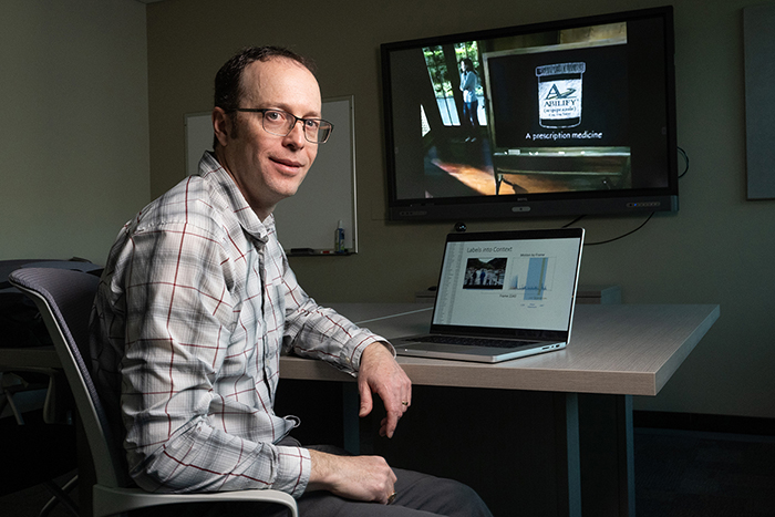 A picture of Jesse King at a computer in his UM office.