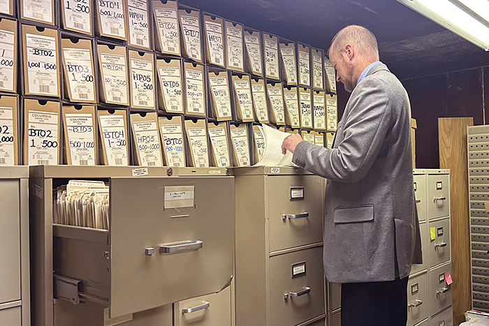 A picture of law student Travis Roush working with files.
