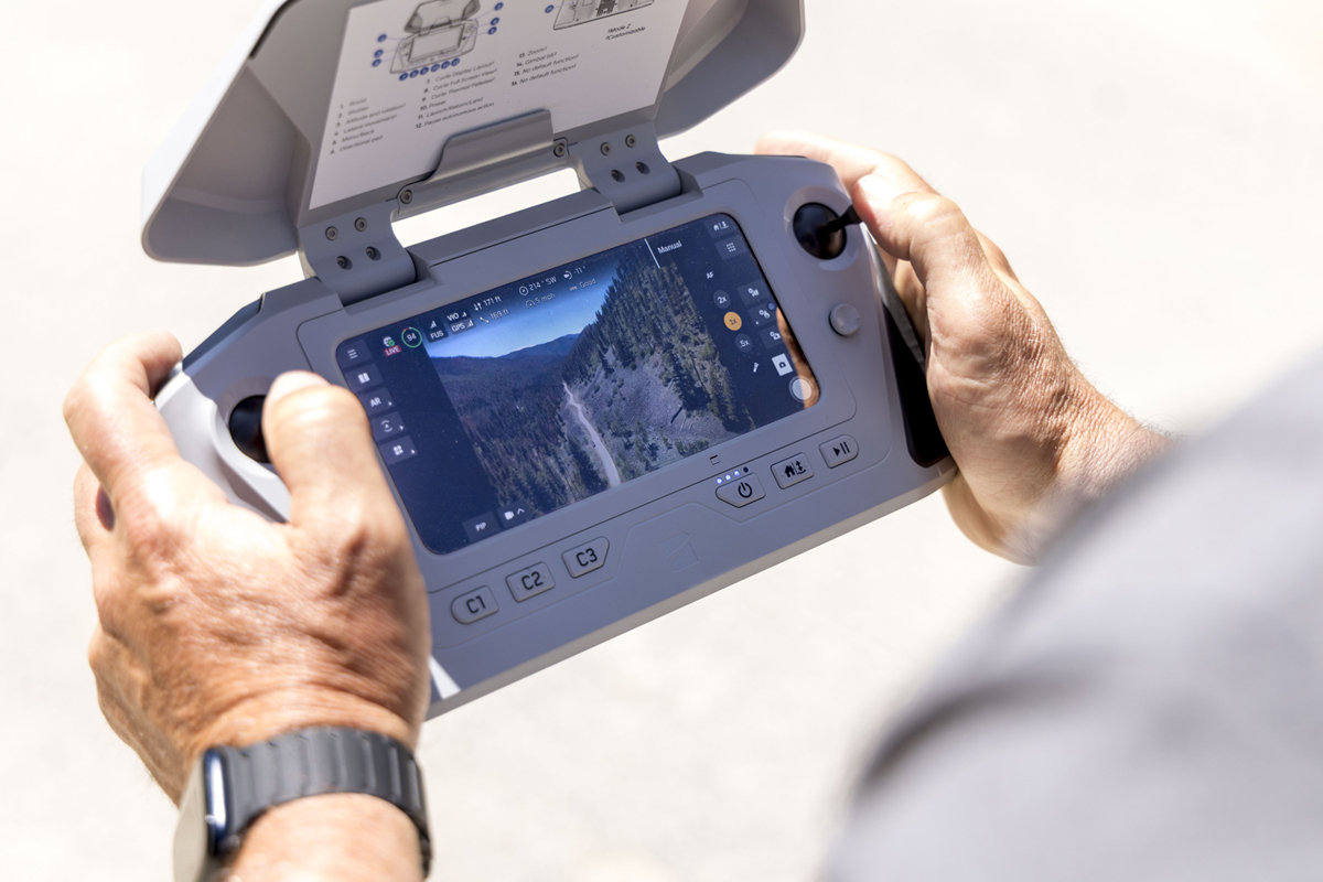 A handheld drone controller showing what the drone is seeing from the sky. 