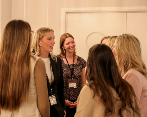 Maya Haugan meets with attendees at the Women in Business Symposium.