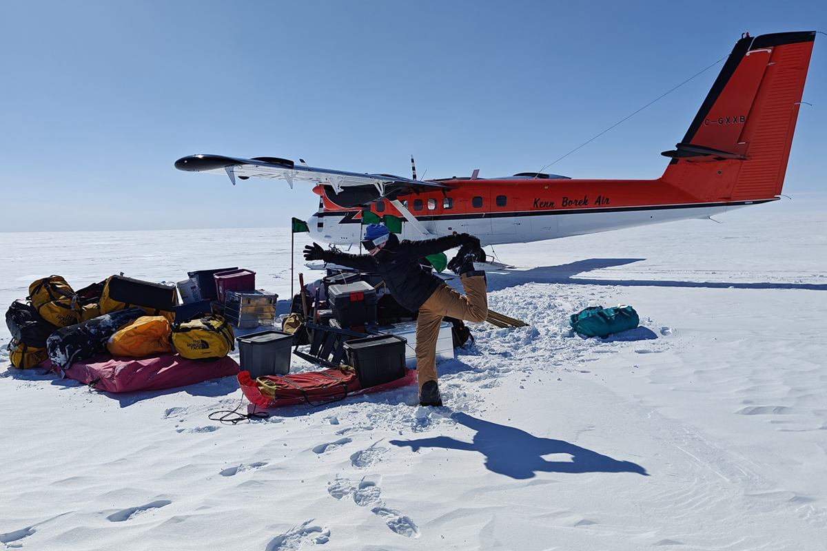 An image of Gehl out on the ice sheet with a snow plane behind her. 