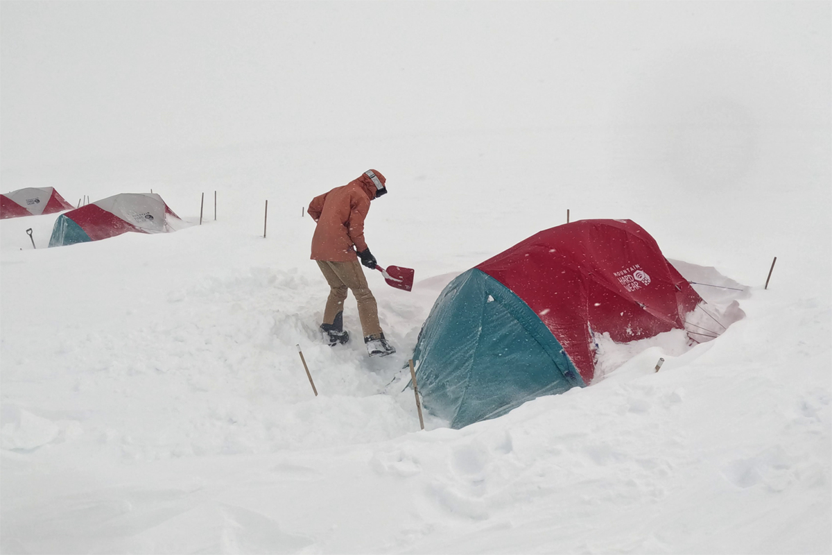 An image of tents buried in snow at the field site.