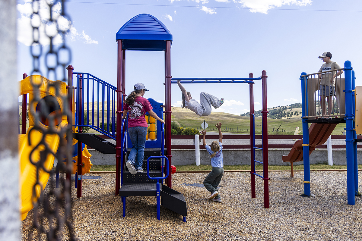 Students play on playground equipment at Malmborg School.